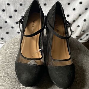 Black wedge high heels.